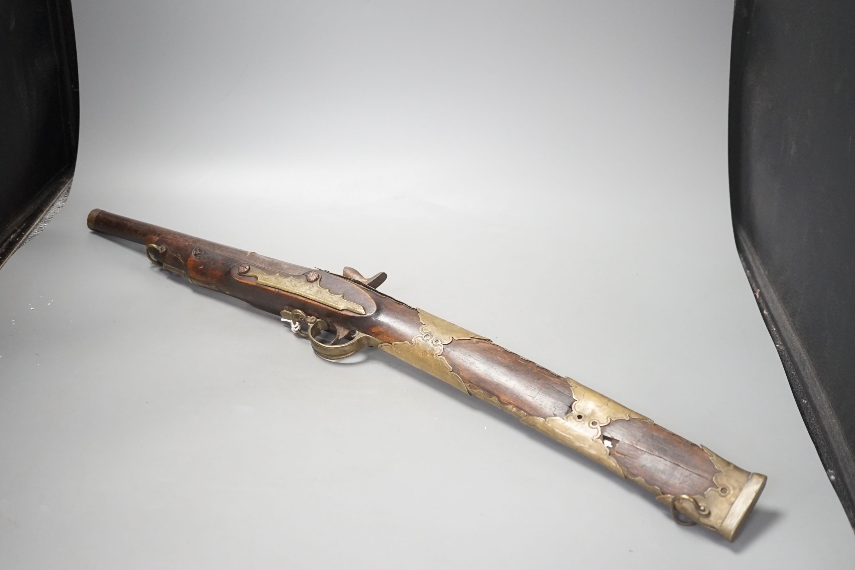 An Ottoman Empire brass-mounted percussion rifle with dual-action concealed barrel sword blade, total length 71cm